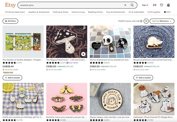 Screenshot of a laptop screen shows results from a search by enamel pins on Etsy. There are eight results, side by side, but all the results display is the name of the products and the price, which highlights how challenging it is to sell enamel pins on marketplaces.