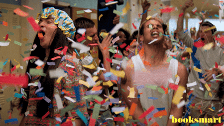 Gif image shows a scene from the movie booksmart where the characters are throwing confetti in the air. This image is to illustrate the excitement of launching a store to sell digital products online.