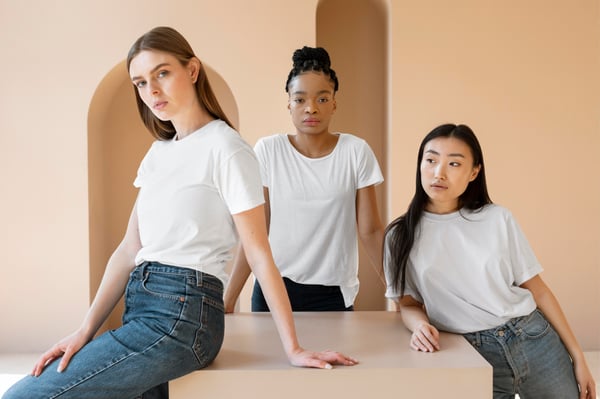 Photo shows three women wearing white t-shits as a reference to the print-on-demand service, a business model to make merch and sell merch.