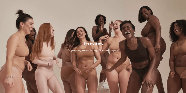 Sweaty Betty about page, with various models with different bodies wearing their products, with their logo and their Unique Selling Proposition in the middle.